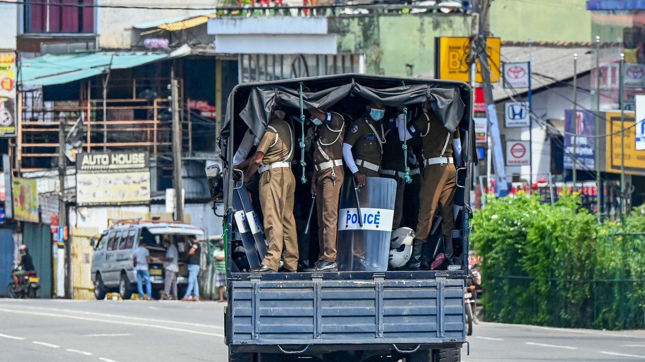 Police patrol the streets after authorities imposed a nationwide weekend curfew to contain protests over a worsening economic crisis, in Colombo on April 3, 2022. Armed troops in Sri Lanka had a tense confrontation with a crowd protesting a worsening economic crisis.